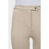 Beige flared trousers with stitched creases
