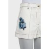 White denim shorts with patches