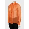 Translucent orange blouse