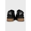 Black leather round toe pumps