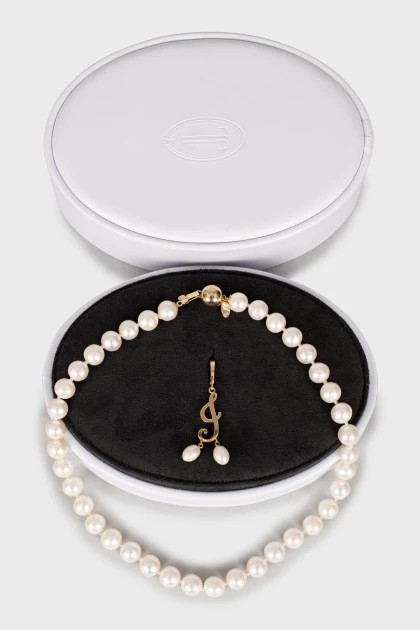 Gold mono earring and pearl necklace