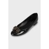 Black leather ballet shoes decorated with a bow