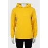 Yellow hoodie with embossed logo