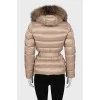 Beige down jacket with fur on the hood