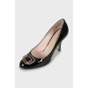 Patent leather shoes with metallic decor