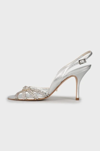 Silver sandals decorated with rhinestones
