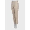 Beige trousers with stitched creases