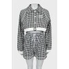Suit in houndstooth print with tag