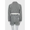 Suit in houndstooth print with tag