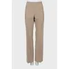 Beige trousers with arrows