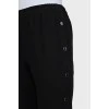 Elastic trousers with silver buttons