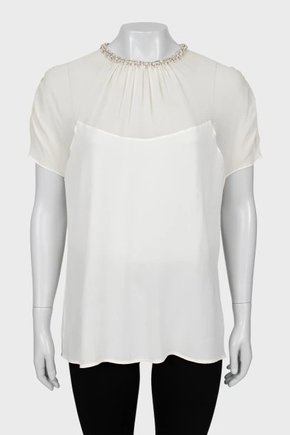 White blouse decorated with rhinestones