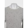 Knitted gray sweater decorated with rhinestones