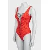 One-piece swimsuit with laces and tag