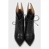 Leather ankle boots decorated with laces