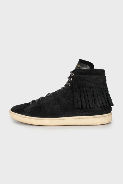 Suede sneakers decorated with fringes