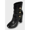 Leather ankle boots with gold buttons