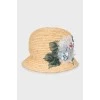 Straw hat decorated with flowers with tag