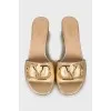 Gold sliders with signature logo