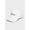 White cap with embroidered print