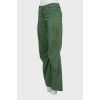 Green trousers decorated with rhinestones