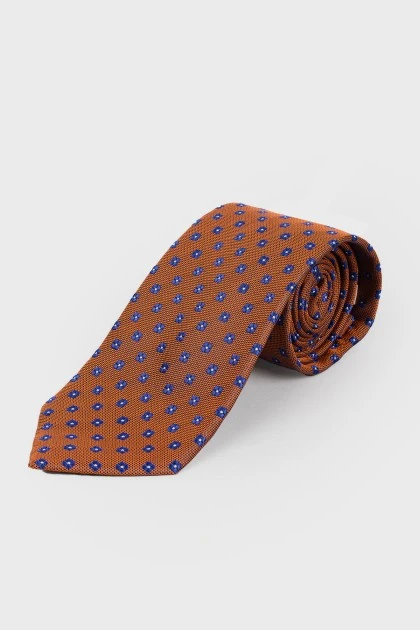 Orange tie in small print