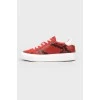 Red sneakers on white sole