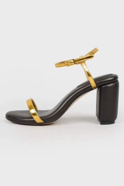 Black sandals with golden straps