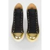 Sneakers with a golden toe with a tag