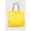 Yellow shopper with a print with a tag