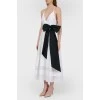 White sundress with a black bow with a tag