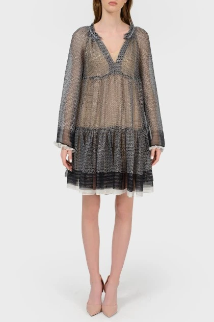 Translucent dress on a beige lining with a tag