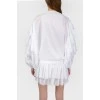 White blouse with stumps on the sleeves with a tag