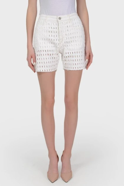 White shorts in a perforation on a lining with a tag