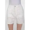 White shorts in a perforation on a lining with a tag