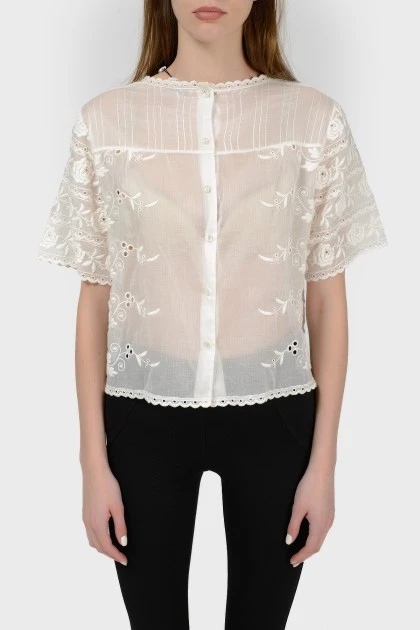 Openwork blouse of a free cut with a tag
