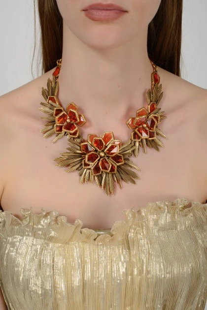 Golden necklace in the form of flowers with amber stones with a tag