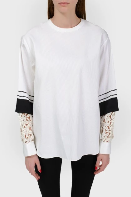 Blouse with lace inserts on the sleeves with a tag