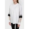 Blouse with lace inserts on the sleeves with a tag
