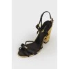 Black sandals with carved metal heels