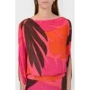 Silk bright dress with a cut on the back