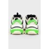 Sneakers with black and light green inserts