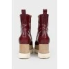 Burgundy boots with white wooden soles