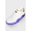 White children's sneakers with a purple sole with a tag