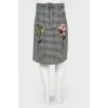 Children's skirt with a floral application with a tag