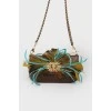 Bag with feathers on a metal chain