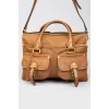 Bag with front buckle pockets