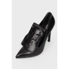 Eros stiletto heels with branded embossed face and tag