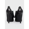 Eros stiletto heels with branded embossed face and tag