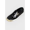 Black slip-ons with gold accents
